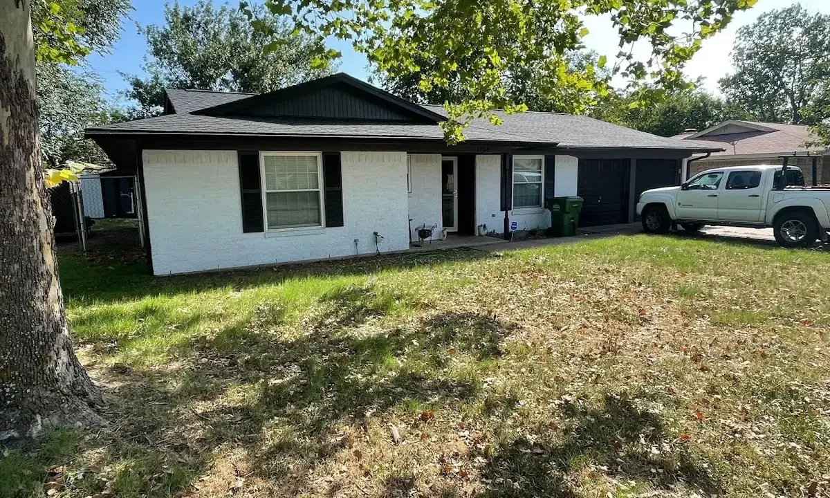 Professional roofing crew working on a residential roof in Eliot